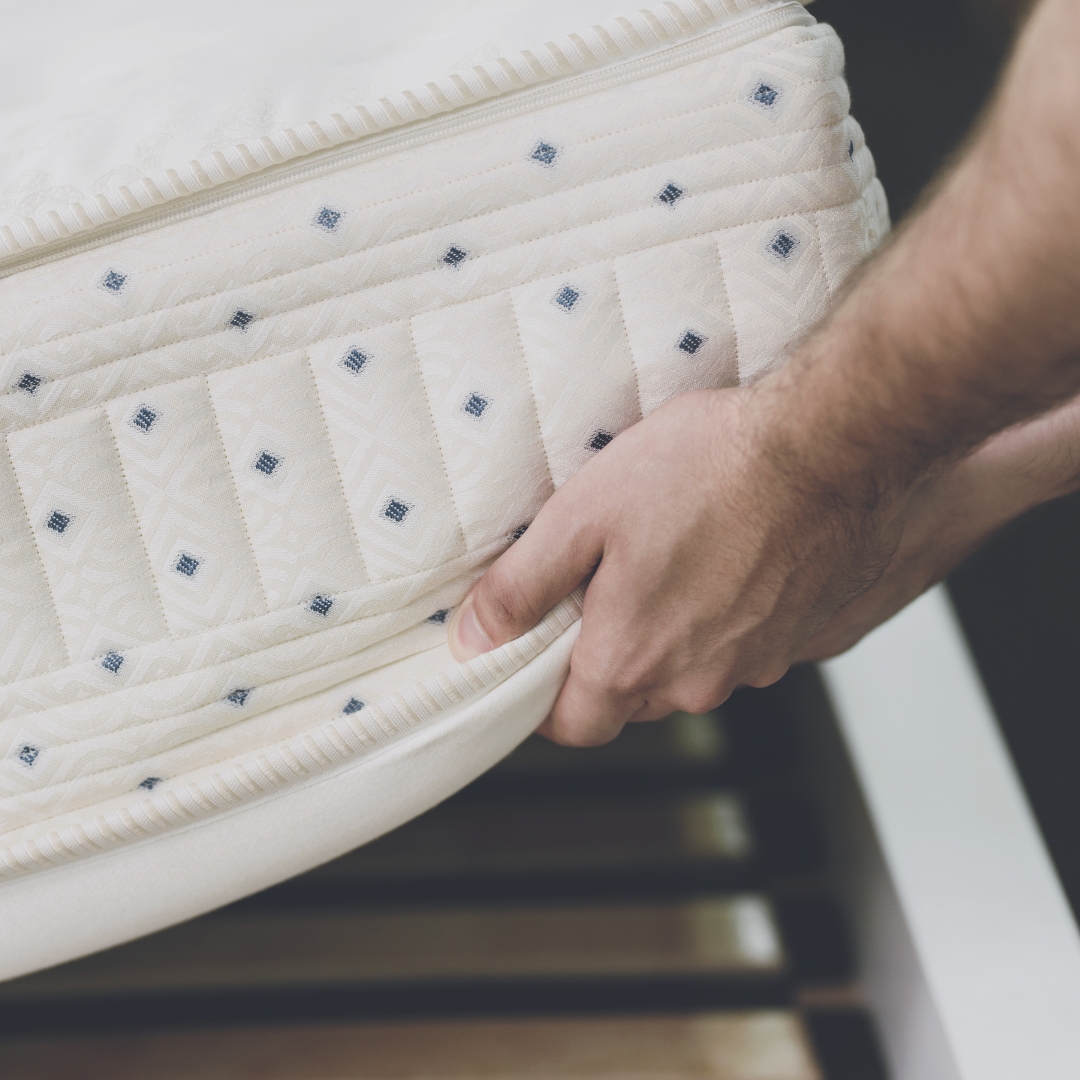 Man lifting the corner of a mattress