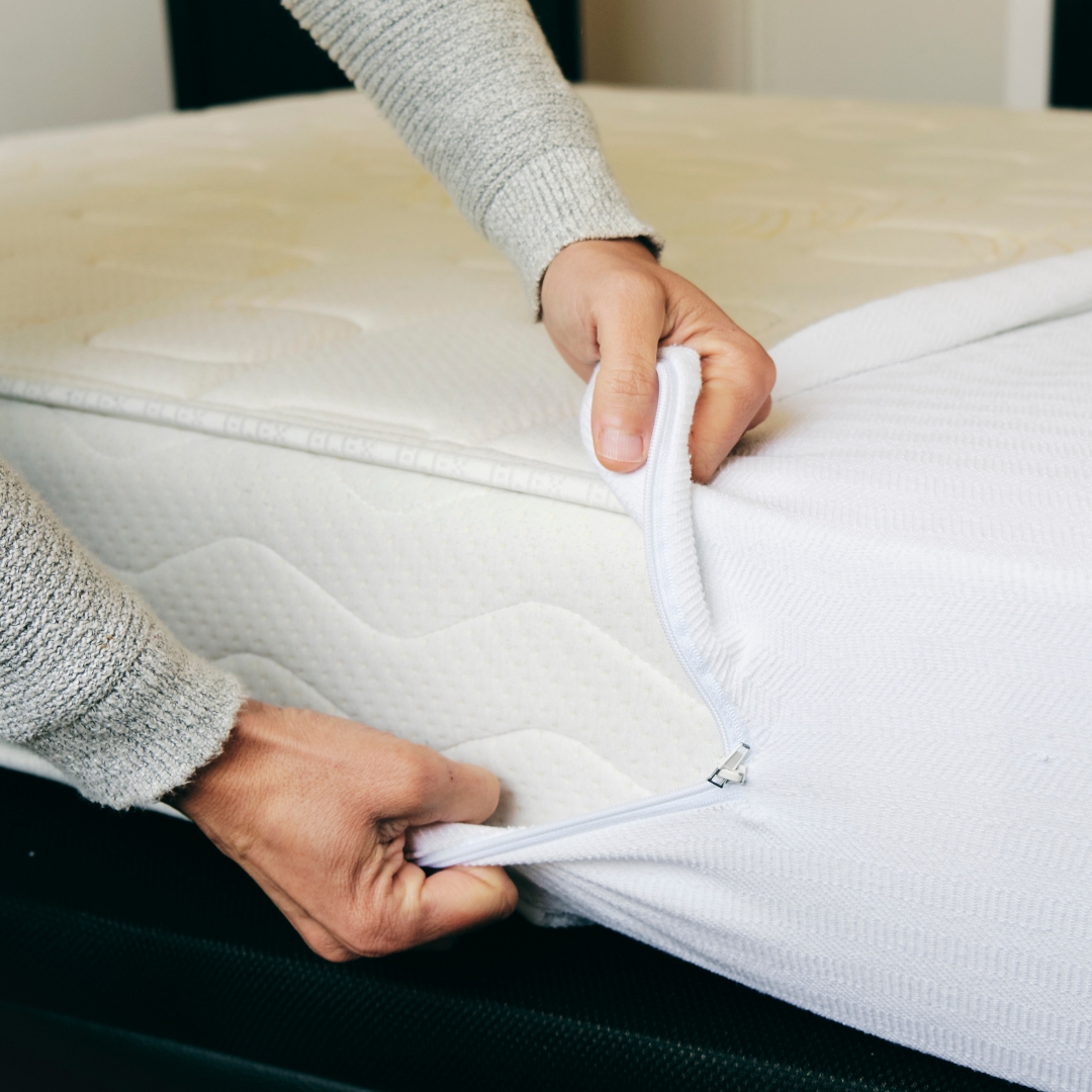 Woman putting a mattress cover on her mattress