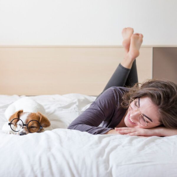 woman on bed with dog