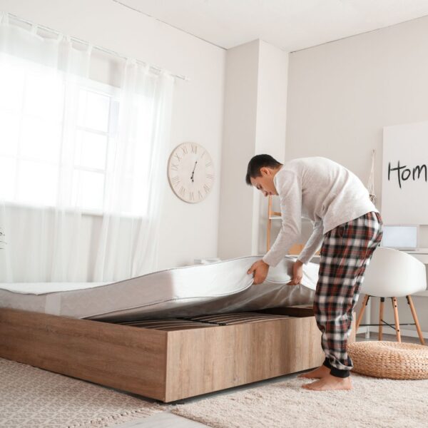 man getting ready to flip mattress