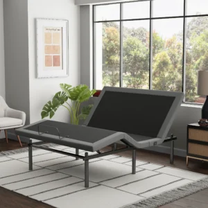 Modern bedroom scene with a gray adjustable bed base partially elevated beside large windows.