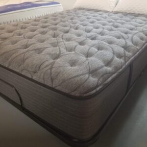 Three-quarter view of the pillow-top mattress on a metal frame, emphasizing its plush depth.
