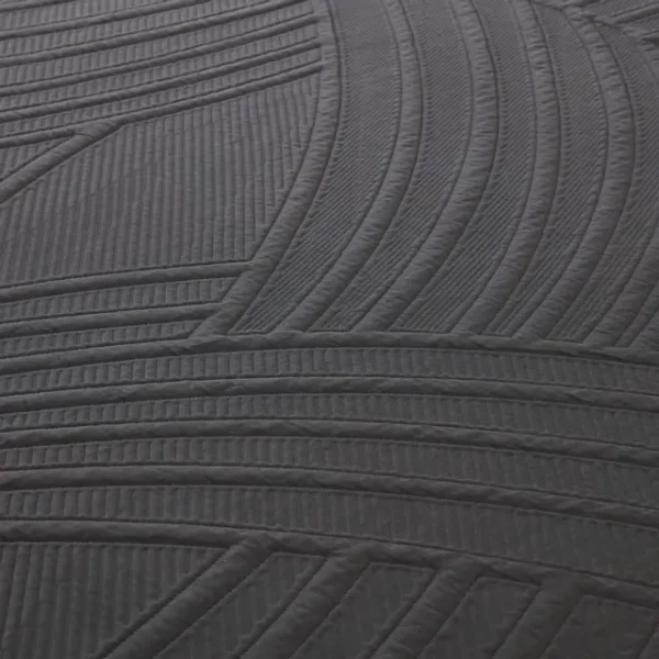 Macro view of the PowerCool cover’s sweeping ribbed quilting pattern in dark grey fabric.
