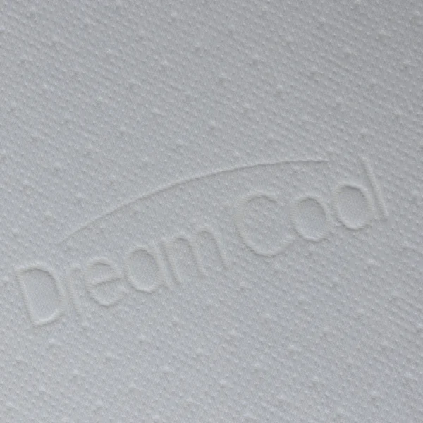 Close-up of white fabric embossed with the “DreamCool” logo and subtle dot texture.