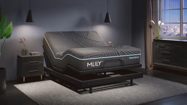 Adjustable base elevating a PowerCool mattress under moody lighting in a contemporary bedroom.