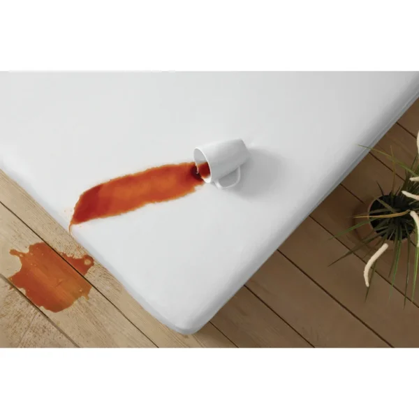 Dark beverage spills across a white protector, while excess drips harmlessly to the floor.